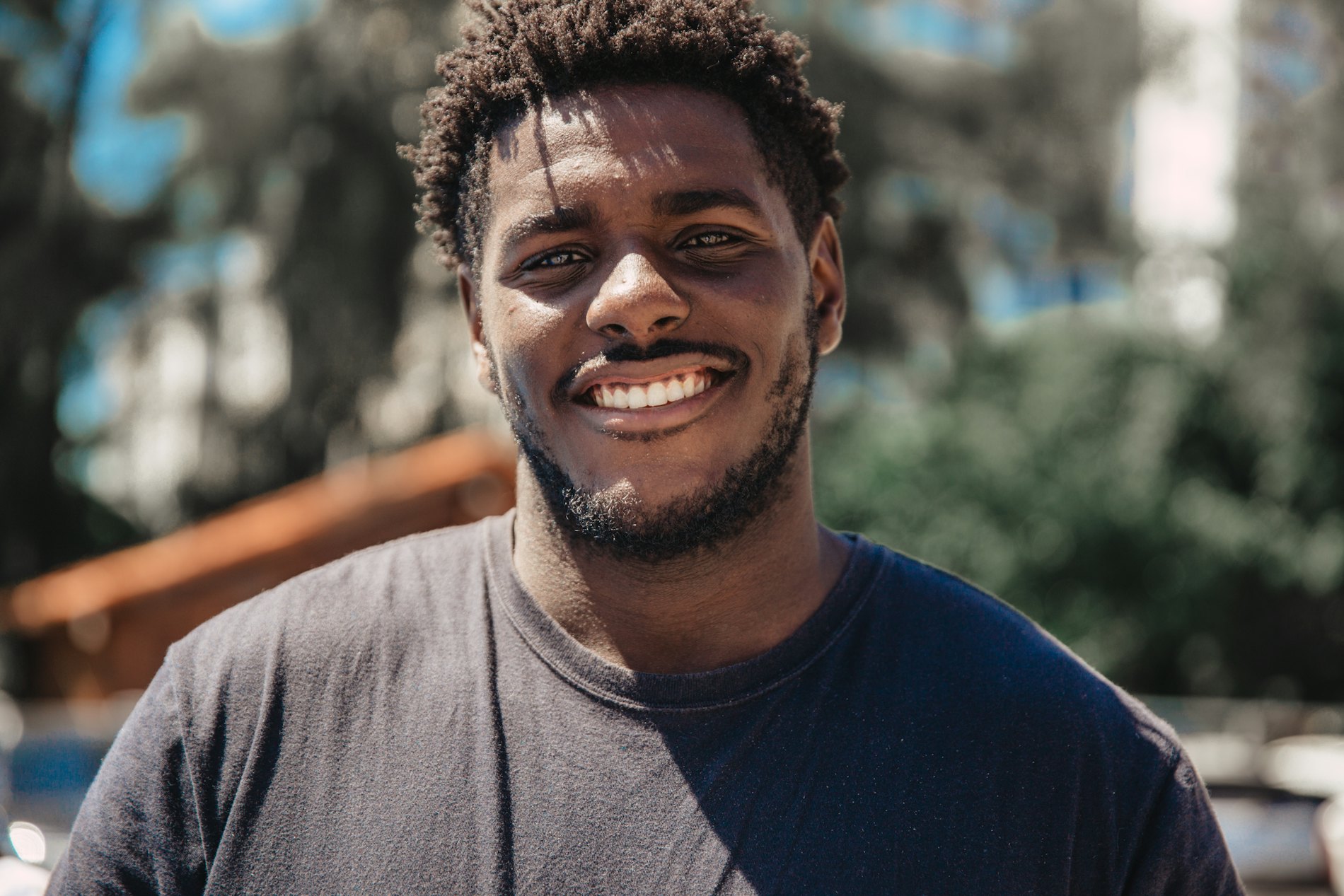 A young man with a warm, open expression